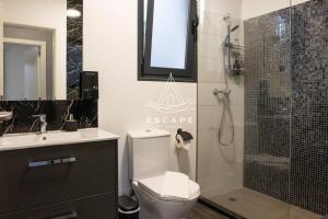 a bathroom with a toilet and a glass shower at Cottage Bela Vista by Escape to Madeira in Cedros +49 photos