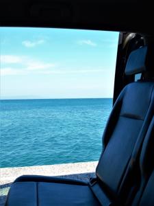 a view of the ocean from the back seat of a vehicle at House100 in Kos Town
