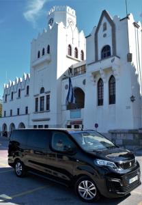 a black van parked in front of a building at House100 in Kos Town
