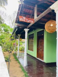 a building with a sign that reads wild turtle at Villa Turtle in Galle