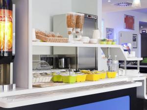 a shelf with a bunch of food on it at ibis budget Besançon Ecole Valentin in Besançon