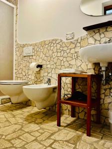 a bathroom with two sinks and a toilet at Affittacamere La Grotta Magica in Venagrande