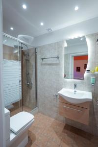 a bathroom with a toilet and a sink and a shower at Ipsos Wave Apartments in Ipsos +287 photos