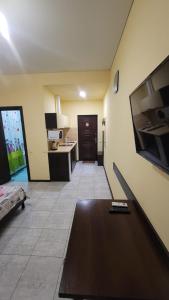 a living room with a table and a tv on a wall at Apartment in the city centr Bursatsky descent in Kharkiv