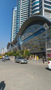 a large building with cars parked in a parking lot at One Bedroom apartment Centaurus Islamabad in Islamabad