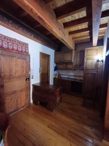 a kitchen with wooden cabinets and a wooden floor at Apartment with fireplace near the Vauban City in Briançon