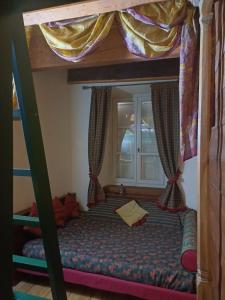 a bunk bed in a room with a window at Apartment with fireplace near the Vauban City in Briançon