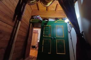 a room with a green door in a house at Apartment with fireplace near the Vauban City in Briançon +2 photos