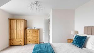 a bedroom with a bed and a wooden dresser at Sea The View in Rothesay