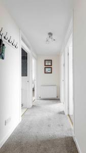 an empty room with white walls and a hallway at Sea The View in Rothesay