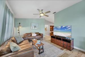 a living room with a couch and a flat screen tv at 227 Goldstein in Punta Gorda
