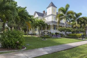 a large yellow house with palm trees in front of it at 227 Goldstein in Punta Gorda