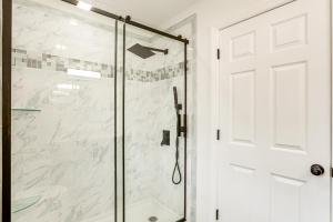 a shower with a glass door in a bathroom at 10 Mi to Lincoln Financial Field Family Home! in Colonial Manor +18 photos