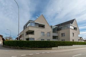 a building on the side of a street at Swiss Suites - Stusslingen in Lostorf