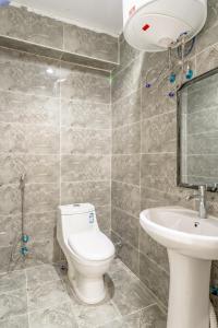 a bathroom with a toilet and a sink at استديو رائع في العليا 203 in Riyadh