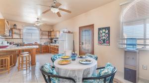 a kitchen with a table with chairs and a refrigerator at Cypress House in Puerto Peñasco