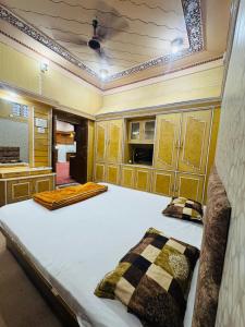 a bedroom with a large bed with two pillows at Perfect Homestay Ujjain in Ujjain