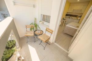 a small balcony with two chairs and a table at Amber Apartman in Banja Koviljača