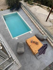 an overhead view of a pool with a table next to it at Villa Maria in Stalos