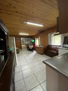 a room with a kitchen and a living room with a table at Sito São Joaquim in Itaquá