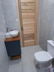 a bathroom with a white toilet and a sink at Sito São Joaquim in Itaquá +36 photos