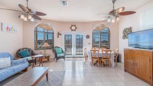 a living room with a couch and a tv at Cypress House in Puerto Peñasco
