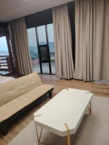 a living room with a couch and a coffee table at كهف الريف Reef Cave in Al Ḩamrāʼ