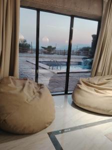 a view of a swimming pool from a room at كهف الريف Reef Cave in Al Ḩamrāʼ