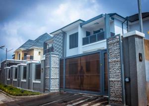 a house with a gate and a garage at Mthree residence and apartment Ltd in Abuja