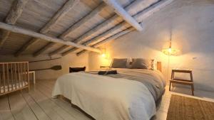 a bedroom with a large white bed with a crib at Villa Oliva São Pedro in São Pedro do Corval +39 photos