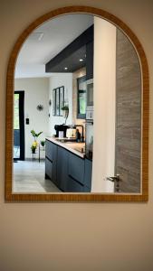 a kitchen with a mirror on the wall at A CASA DI GHJULIA PISCINE CHAUFFEE PROCHE St FLORENT in Vallecalle