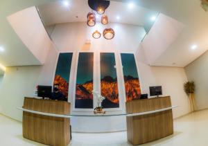 a lobby with a view of a mountain mural on the wall at Hotel Rochedo, Penedo - Alagoas in Penedo