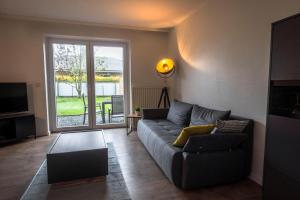 a living room with a couch and a table at Deichkoje 1 Dagebüll in Dagebüll