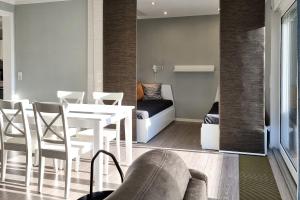 a living room with a table and chairs and a couch at Haus Spökenkieker in Borkum