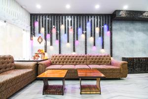 a living room with a couch and a table at Hotel O Radha Krishna Residency in Nagri