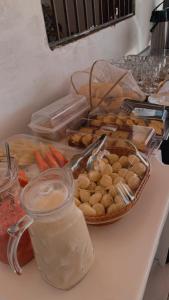 a table with a plate of food and a basket of vegetables at Sol Dos Lençois Pousada in Barreirinhas