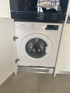 a washing machine with its door open in a kitchen at Colina Blanca Apartament Mirador Azul in Adeje