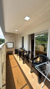 un soggiorno con sedie, tavolo e camino di Apto Flor Três Marias-2 Quartos- Apto todo climatizado- Moderno, confortável, à 150m do Parque Termal a Piratuba