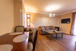 een woonkamer met een tafel en een bank bij Villa Rusalka in Vysoké Tatry