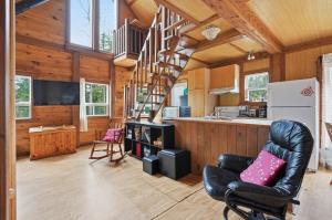 a kitchen and living room with a spiral staircase in a house at The Tiny Cozy Retreat in Saint-Just-de-Bretenières +14 photos