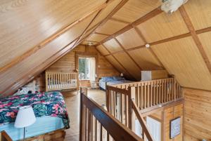 a log cabin with a bedroom and a bed at The Tiny Cozy Retreat in Saint-Just-de-Bretenières