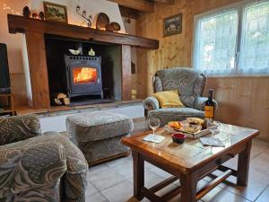 a living room with a table and a fireplace at Gîte des Gravets in Sigalens