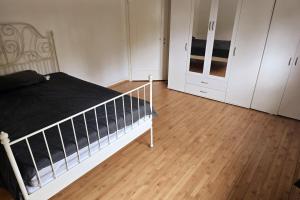 a bedroom with a bed and white cabinets at Helle, gemütliche Wohnung an der grenze vom Deutschland in Koblenz