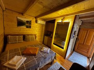a small room with a bed in a wooden house at Brvnara Toma in Cetinje