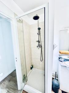 a shower with a glass door in a bathroom at Treasure of Perche-Gouët in a village house! in Arrou +11 photos