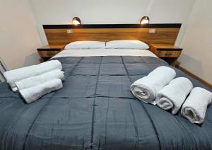 a bedroom with a large bed with towels on it at Rifugio TEA Dolomiti in Caviola