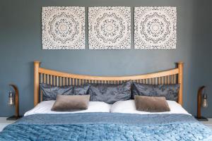 a bedroom with a large bed with two pillows at Cyclists Rest Matlock in Matlock