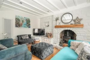 a living room with a couch and a fireplace at Cyclists Rest Matlock in Matlock