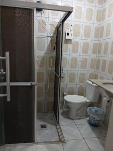 a bathroom with a shower with a toilet and a sink at Casa de Elvira in Belém