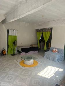 a living room with green curtains and a tub in a room at Casa de Elvira in Belém
